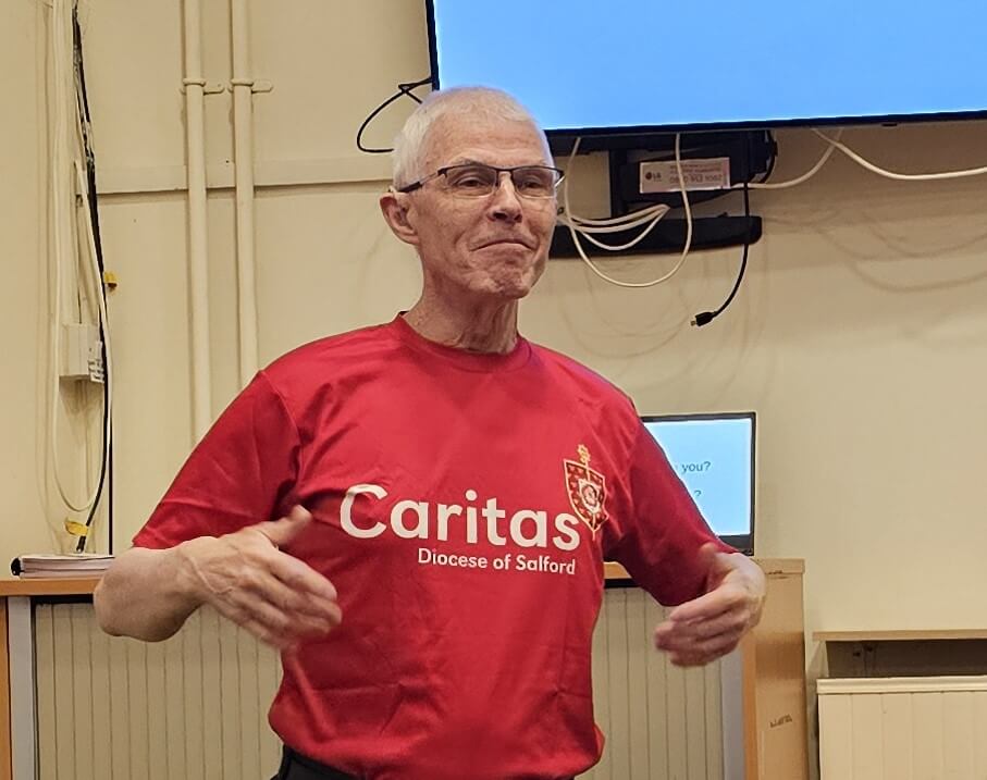 Man in red Caritas branded tshirt