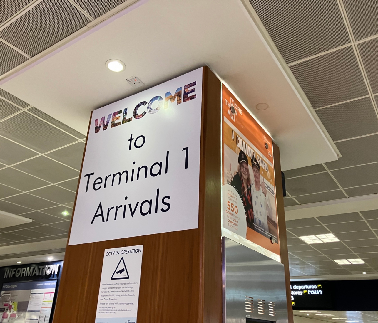 Sign in airport on pillar saying welcome to terminal 1 arrivals