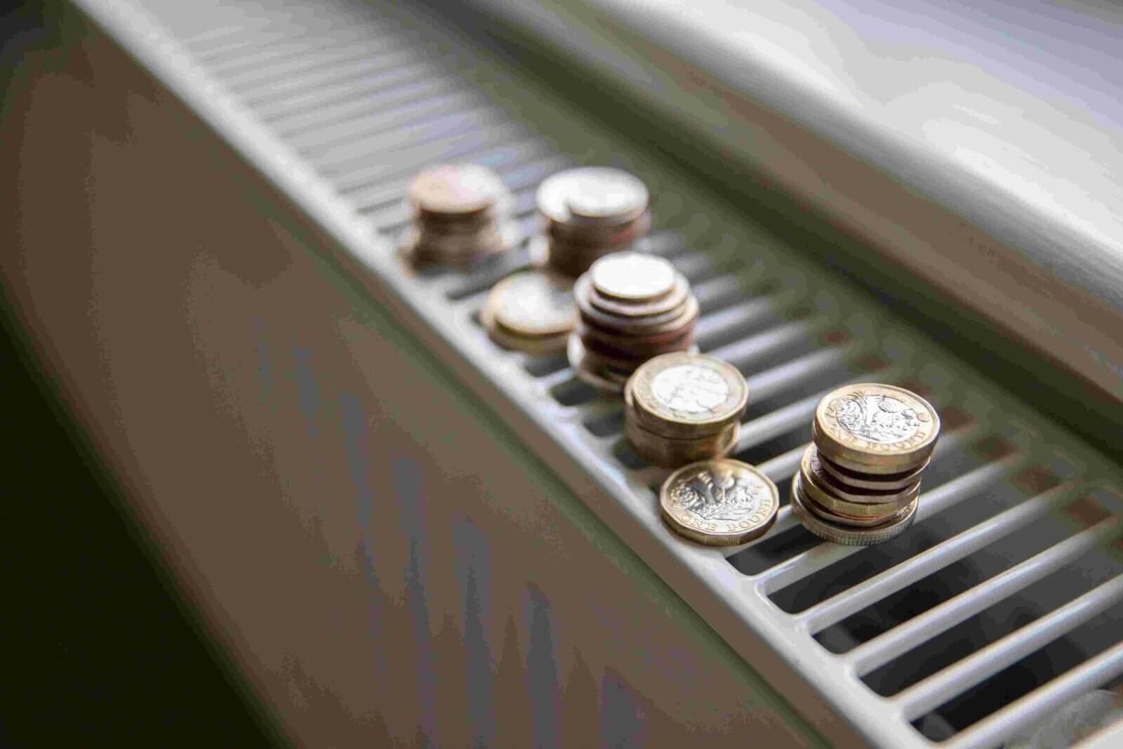 Close up of coins on top of white radiator